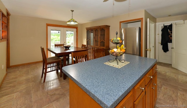 215 White Birch Dr, Southbury, CT 06488 - kitchen featuring dark countertops, freestanding refrigerator, a kitchen island, french doors, and a ceiling fan