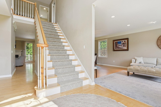 61 Brookview Ct, Groton, CT 06340 - stairway featuring wood finished floors, crown molding, and recessed lighting
