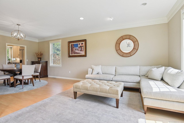 61 Brookview Ct, Groton, CT 06340 - living area with crown molding, a chandelier, and light wood finished floors