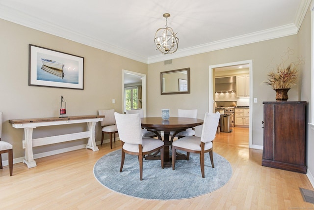 61 Brookview Ct, Groton, CT 06340 - dining area with light wood finished floors, a chandelier, and crown molding