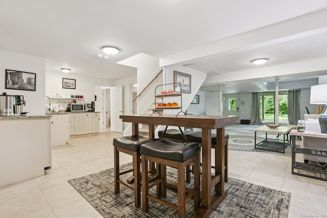 61 Brookview Ct, Groton, CT 06340 - dining space with light tile patterned flooring and stairs