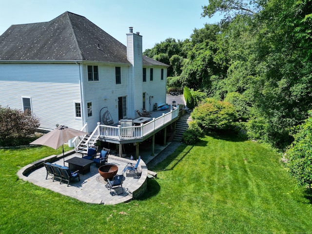 61 Brookview Ct, Groton, CT 06340 - back of house featuring a chimney, a wooden deck, a yard, and a patio area