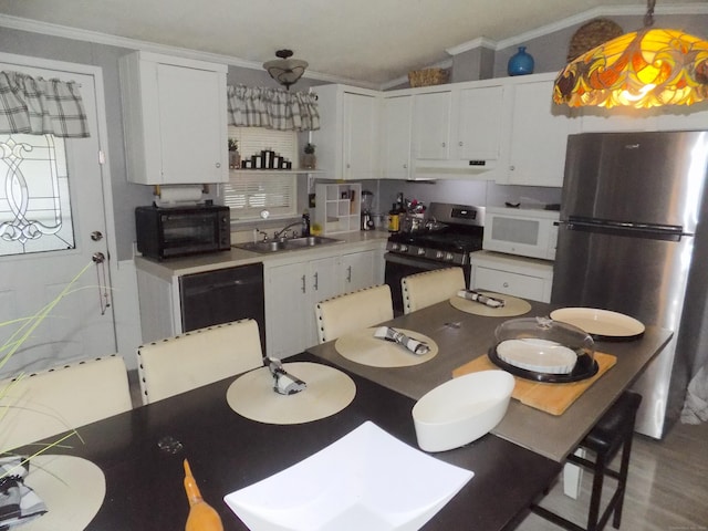 61 Elm St, East Windsor, CT 06088 - kitchen with appliances with stainless steel finishes, extractor fan, ornamental molding, white cabinets, and light countertops