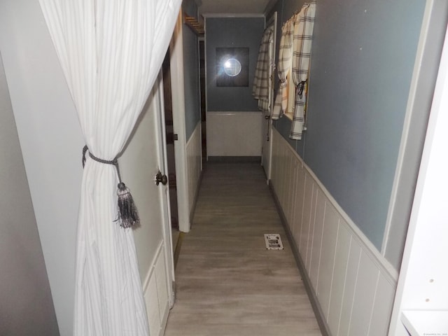 61 Elm St, East Windsor, CT 06088 - hallway with light wood-type flooring, a decorative wall, and wainscoting