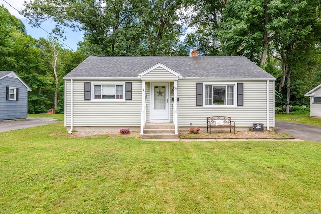 76 Landers Rd, East Hartford, CT 06118 - view of front of home featuring a front lawn, a shingled roof, and a chimney
