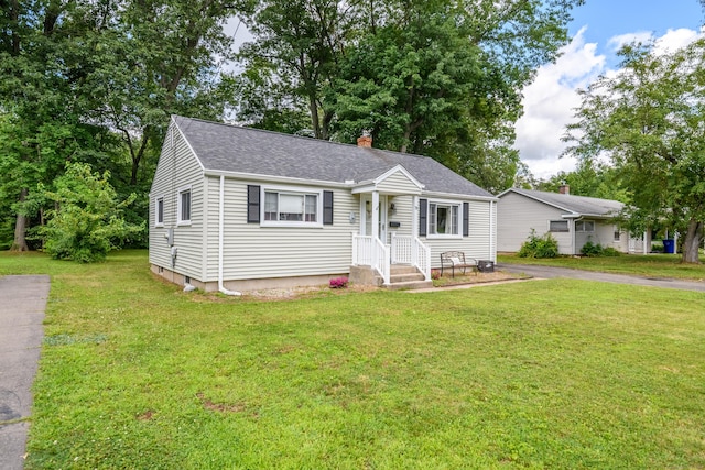 76 Landers Rd, East Hartford, CT 06118 - view of front of property with a front lawn, roof with shingles, and a chimney