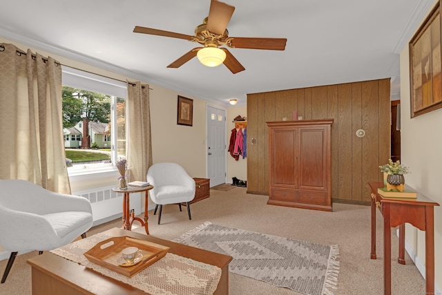 76 Landers Rd, East Hartford, CT 06118 - living area with radiator heating unit, light carpet, ceiling fan, and wooden walls