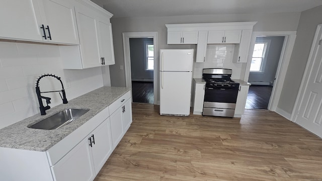 62 Miller St, New Britain, CT 06053 - kitchen featuring freestanding refrigerator, stainless steel gas range, tasteful backsplash, and baseboard heating