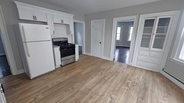 62 Miller St, New Britain, CT 06053 - kitchen with freestanding refrigerator, stainless steel gas range oven, a baseboard radiator, and healthy amount of natural light