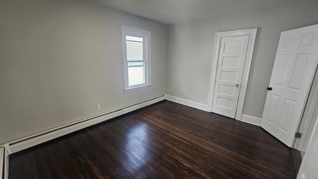 62 Miller St, New Britain, CT 06053 - unfurnished bedroom with a baseboard heating unit and dark wood finished floors