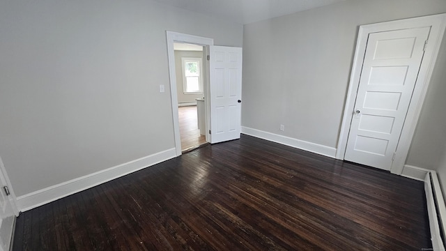 62 Miller St, New Britain, CT 06053 - spare room featuring dark wood-style floors, a baseboard radiator, and a baseboard heating unit