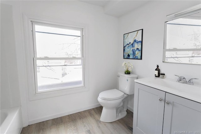 33 William St, Danbury, CT 06810 - full bathroom featuring vanity, healthy amount of natural light, a tub to relax in, and wood finished floors