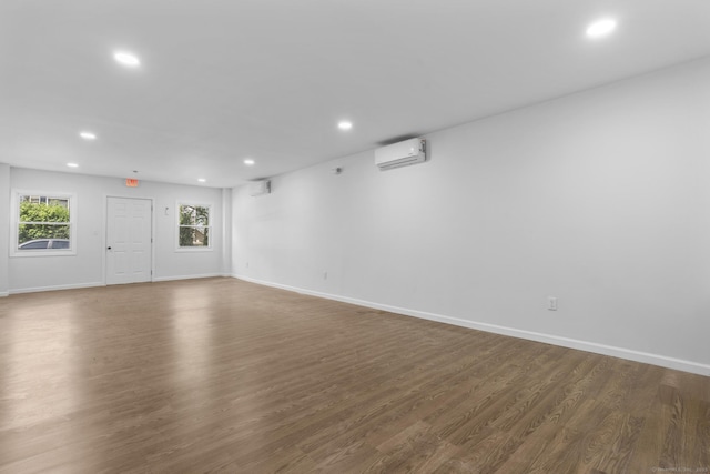 33 William St, Danbury, CT 06810 - unfurnished living room with a wall mounted air conditioner, recessed lighting, and wood finished floors