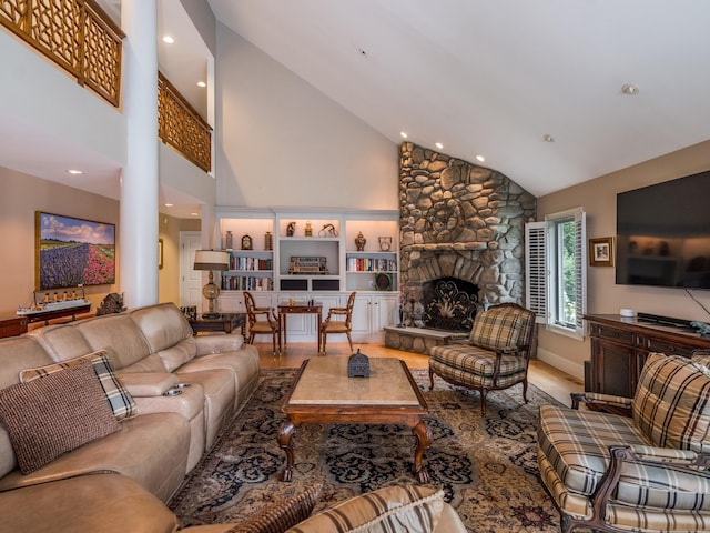8 Up The Rd, Simsbury, CT 06092 - living area featuring high vaulted ceiling, wood finished floors, a stone fireplace, recessed lighting, and decorative columns