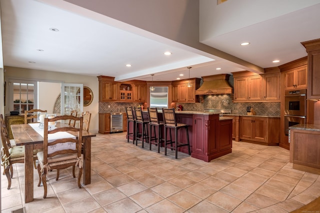 8 Up The Rd, Simsbury, CT 06092 - kitchen featuring brown cabinetry, backsplash, a kitchen island, a breakfast bar area, and recessed lighting