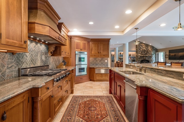 8 Up The Rd, Simsbury, CT 06092 - kitchen with backsplash, open floor plan, a fireplace, brown cabinetry, and recessed lighting