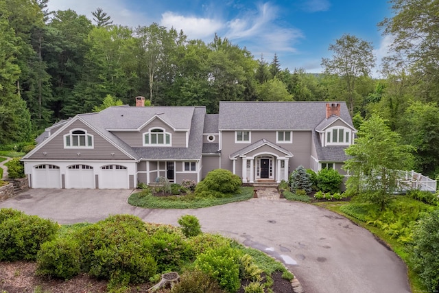 8 Up The Rd, Simsbury, CT 06092 - view of front of property featuring a chimney, driveway, and roof with shingles