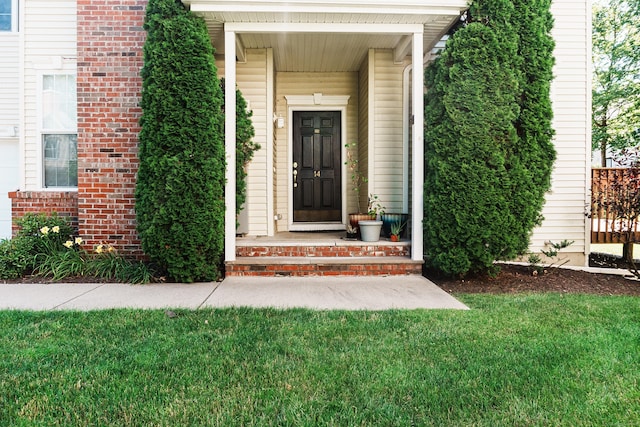 14 Last Leaf Cir Unit 14, Windsor, CT 06095 - view of exterior entry featuring a lawn, covered porch, and brick siding