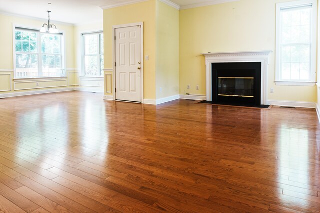 14 Last Leaf Cir Unit 14, Windsor, CT 06095 - unfurnished living room featuring crown molding, dark wood-type flooring, a fireplace with flush hearth, and a chandelier