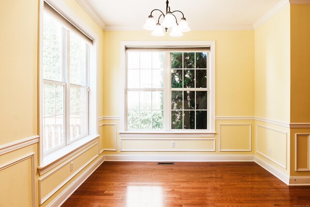 14 Last Leaf Cir Unit 14, Windsor, CT 06095 - unfurnished dining area featuring a chandelier, wood finished floors, crown molding, and a wainscoted wall