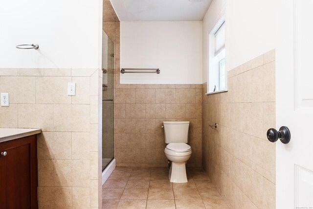 14 Last Leaf Cir Unit 14, Windsor, CT 06095 - bathroom featuring tile walls, a shower stall, vanity, tile patterned floors, and wainscoting