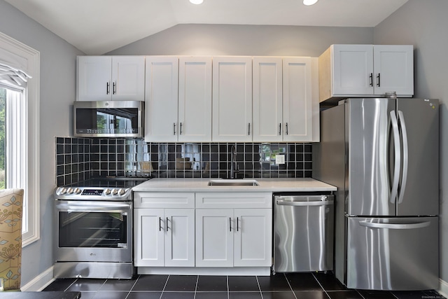 106A Comstock Hill Ave, Norwalk, CT 06850 - kitchen featuring appliances with stainless steel finishes, light countertops, vaulted ceiling, white cabinets, and backsplash
