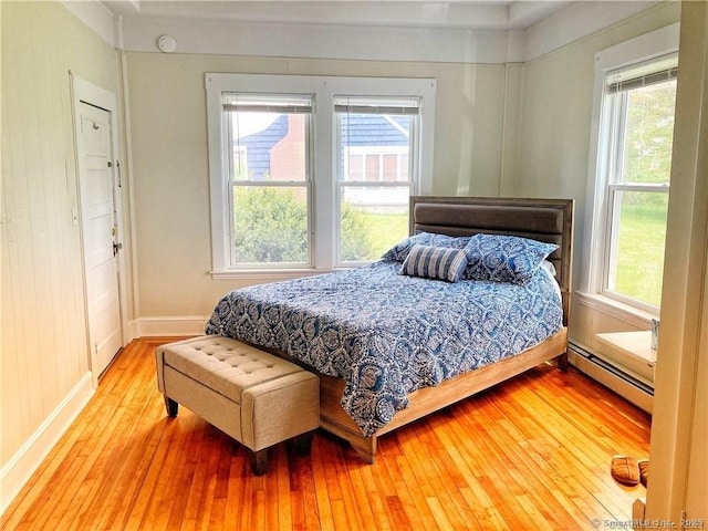 288 Benham Rd, Groton, CT 06340 - bedroom with a baseboard heating unit, hardwood / wood-style flooring, and multiple windows