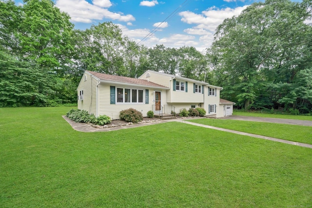18 Arbor Rd, Monroe, CT 06468 - tri-level home with a front lawn, a garage, asphalt driveway, and view of wooded area