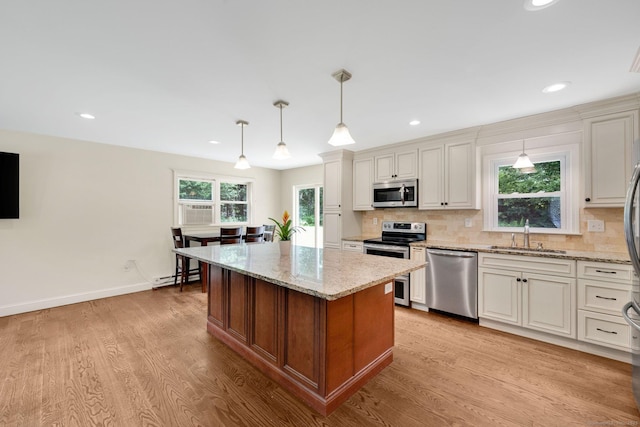 18 Arbor Rd, Monroe, CT 06468 - kitchen featuring appliances with stainless steel finishes, baseboard heating, light wood-type flooring, decorative backsplash, and recessed lighting