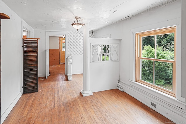 326 Rte 169, Woodstock, CT 06281 - spare room featuring light wood finished floors, healthy amount of natural light, and decorative columns