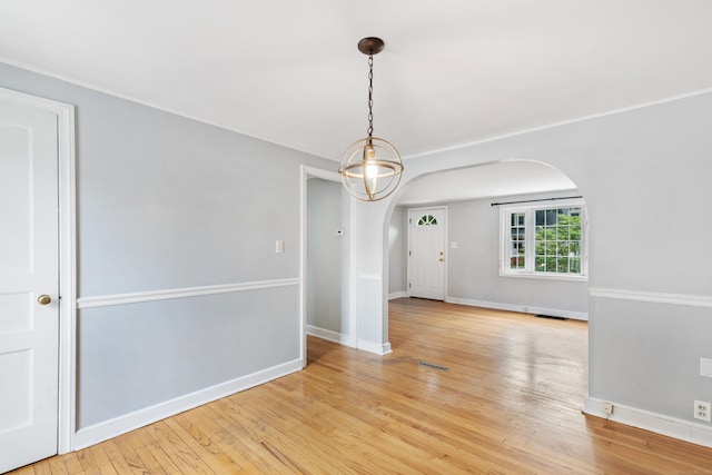 3 Lynette Dr, North Haven, CT 06473 - empty room with arched walkways and light wood-style floors
