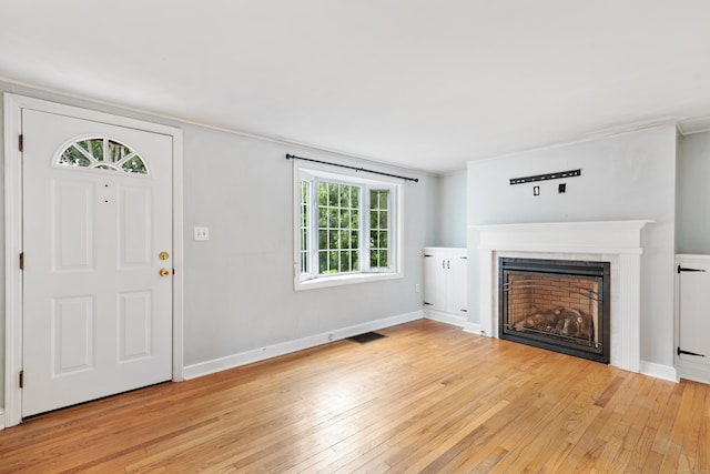3 Lynette Dr, North Haven, CT 06473 - unfurnished living room featuring light wood-style flooring, a fireplace, and crown molding