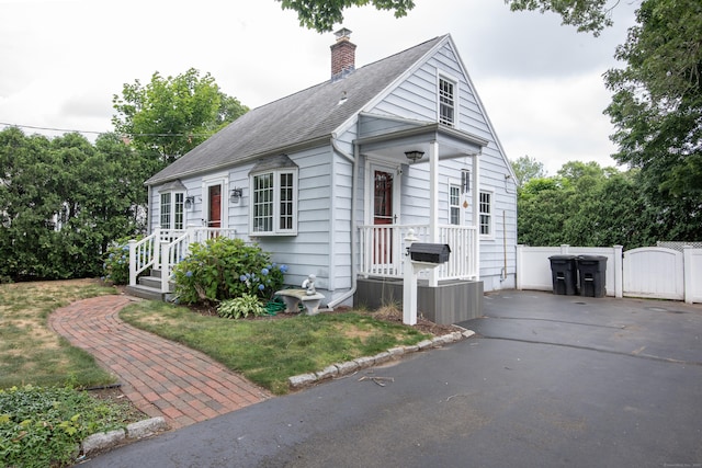 3 Lynette Dr, North Haven, CT 06473 - view of front of house with a gate, a chimney, driveway, and a shingled roof
