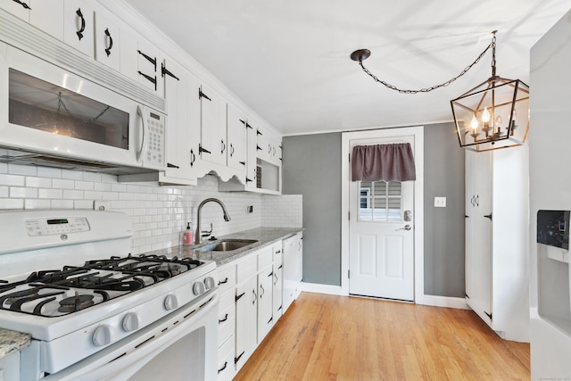 3 Lynette Dr, North Haven, CT 06473 - kitchen with white appliances, tasteful backsplash, a chandelier, light wood-style floors, and white cabinetry