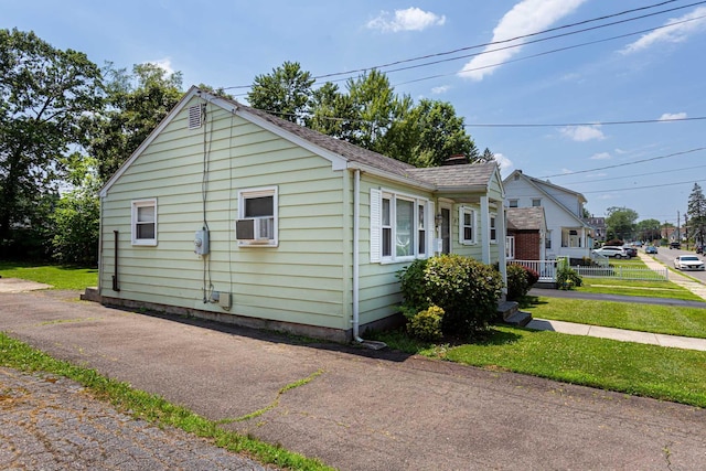 19 Marion St, Hartford, CT 06106 - view of side of home featuring cooling unit, a shingled roof, and a chimney