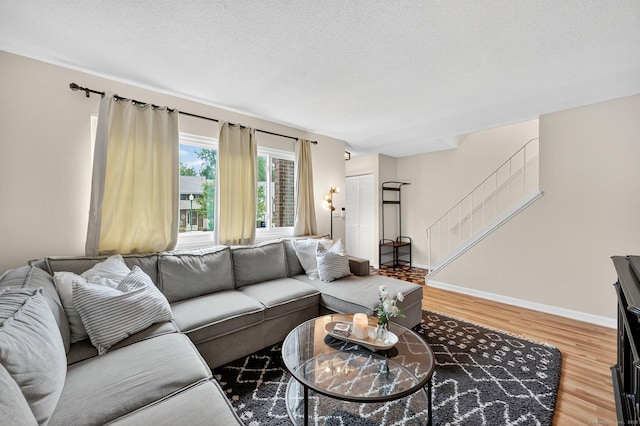 182 Shagbark Dr Unit 182, Derby, CT 06418 - living room featuring light wood-type flooring, a textured ceiling, and stairway