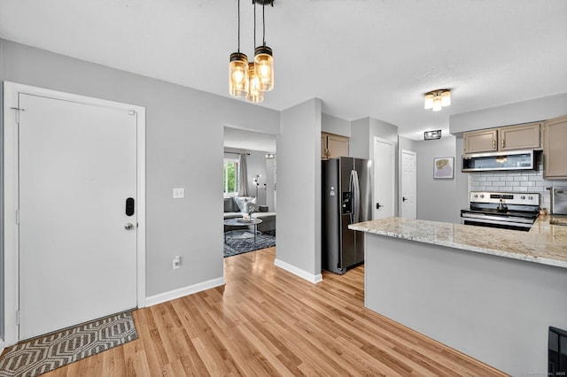 182 Shagbark Dr Unit 182, Derby, CT 06418 - kitchen featuring appliances with stainless steel finishes, light wood-type flooring, backsplash, pendant lighting, and a peninsula