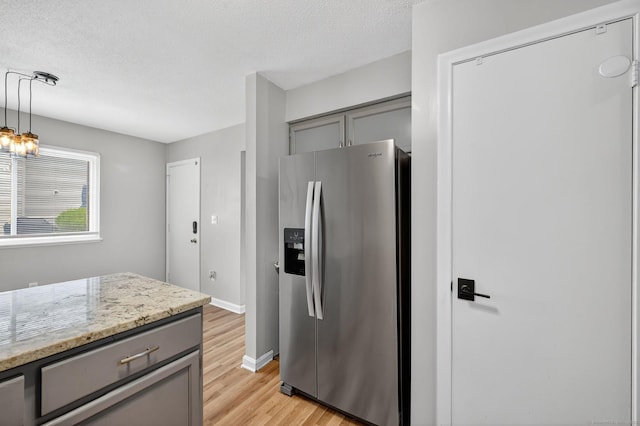 182 Shagbark Dr Unit 182, Derby, CT 06418 - kitchen with stainless steel fridge, gray cabinetry, light wood finished floors, light stone counters, and pendant lighting