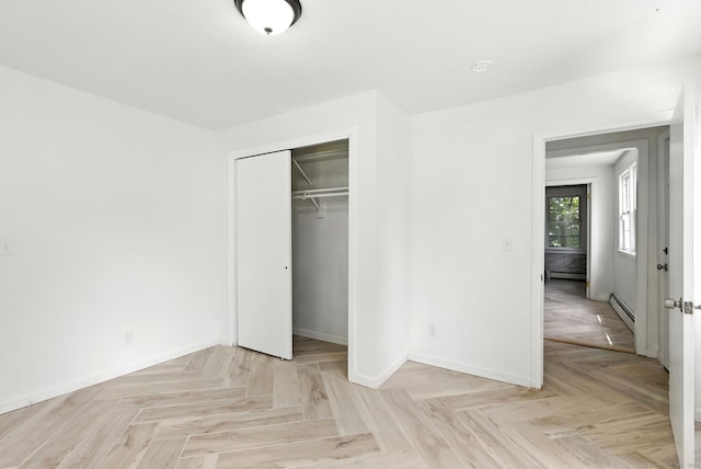 5 Church St Apt R, East Windsor, CT 06016 - unfurnished bedroom featuring a baseboard radiator and a closet