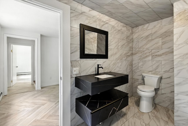 5 Church St Apt R, East Windsor, CT 06016 - bathroom with tile walls, baseboard heating, and vanity
