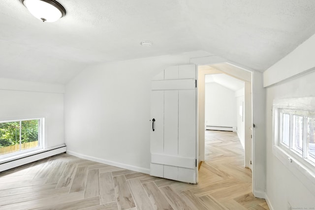 5 Church St Apt R, East Windsor, CT 06016 - bonus room featuring a baseboard radiator, lofted ceiling, and a textured ceiling