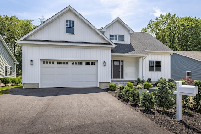 6 Kaatskill Ln, East Lyme, CT 06357 - view of front facade with asphalt driveway and roof with shingles