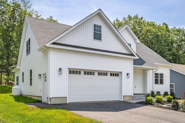 6 Kaatskill Ln, East Lyme, CT 06357 - view of front of home featuring a shingled roof, asphalt driveway, a garage, and board and batten siding
