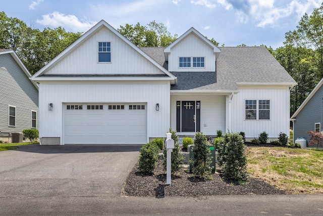 6 Kaatskill Ln, East Lyme, CT 06357 - view of front of home with a shingled roof, asphalt driveway, and a garage