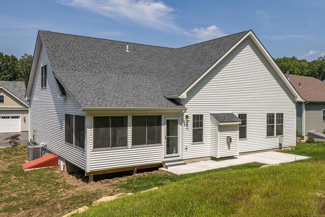 6 Kaatskill Ln, East Lyme, CT 06357 - back of property with entry steps, a shingled roof, a lawn, and a patio area
