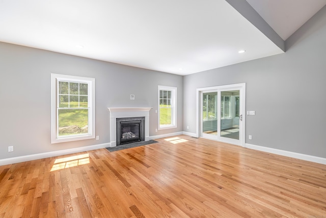 6 Kaatskill Ln, East Lyme, CT 06357 - unfurnished living room featuring a fireplace with flush hearth, plenty of natural light, light wood-type flooring, and recessed lighting
