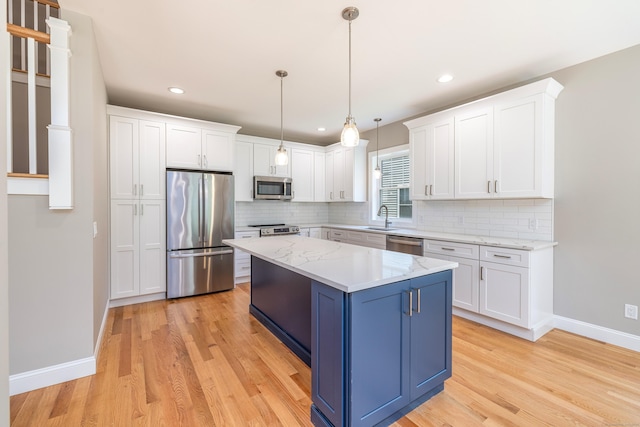 6 Kaatskill Ln, East Lyme, CT 06357 - kitchen with stainless steel appliances, blue cabinetry, white cabinetry, light wood-style flooring, and recessed lighting