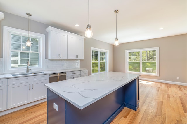 6 Kaatskill Ln, East Lyme, CT 06357 - kitchen with dishwasher, backsplash, white cabinetry, a center island, and hanging light fixtures