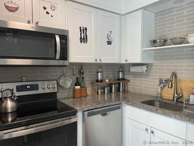 104 N Turnpike Rd Unit B, Wallingford, CT 06492 - kitchen with stainless steel appliances, backsplash, white cabinetry, and stone counters