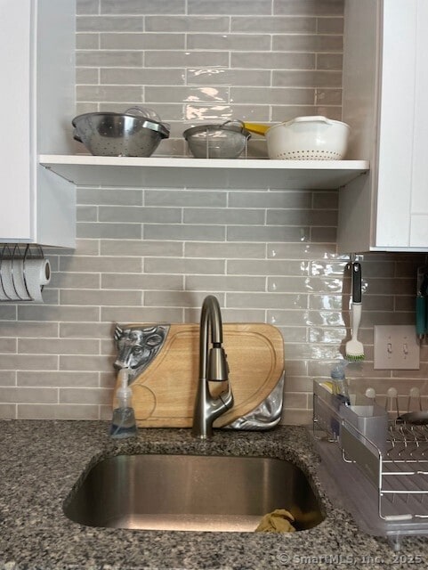 104 N Turnpike Rd Unit B, Wallingford, CT 06492 - kitchen view of backsplash, white cabinetry, dark stone counters, and open shelves